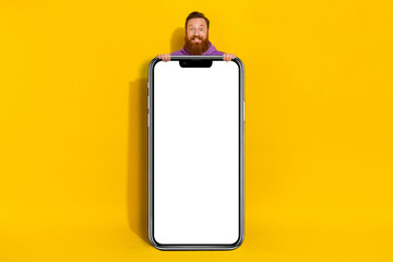 Full body portrait of funny excited person stand behind empty space ui panel isolated on yellow color background