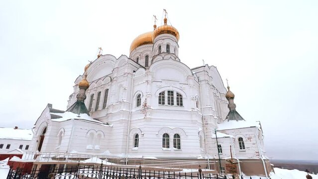 Belogorsky St. Nicholas Orthodox Missionary Monastery. Russia, Perm Krai, Belaya Gora. The temple on the hill in winter. Monastery on the background of snow. 4K