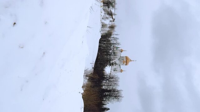 Belogorsky St. Nicholas Orthodox Missionary Monastery. Russia, Perm Krai, Belaya Gora. The temple on the hill in winter. Monastery on the background of snow. 4K