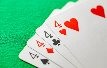 Playing cards, poker combination four of kind, quads, fours of different suits, same value