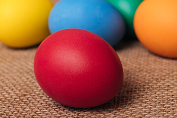 Painted eggs. Colorful Easter eggs on sackcloth. Macro shot, selective focus.