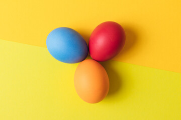 Colorful painted eggs on multicolor background. Concept scene. Easter eggs. Selective focus. Close up, top view.