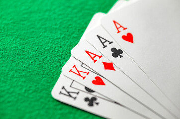 Playing cards, poker combination full house, three aces and two kings cross hearts diamonds suits