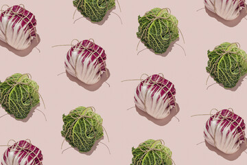 Fresh vegetable pattern with radicchio and kale packed as small packages on pink background. Minimal food concept.