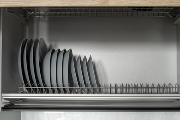 Clean gray plates drying in the kitchen.