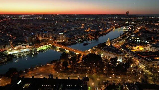 Aerial drone footage of the Seville city the Guadalquivir canal with the cathedral, the Torre del Oro, the tower of gold, Andalusia, Spaine