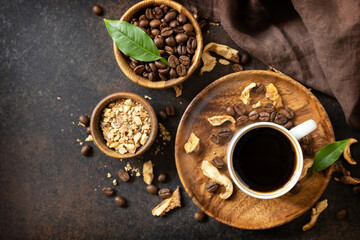 Healthy organic energizing adaptogen. Mushroom coffee in a cup and coffee beans, trendy drink on a stone background. View from above.