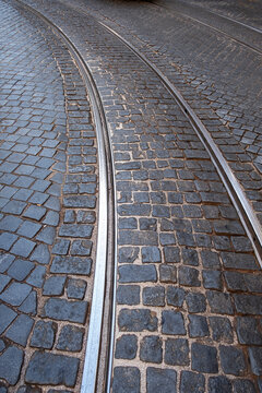 detail of the cobblestone floor of a street in lisbon with the tramway tracks describing a curve in the Alfama district, vertical