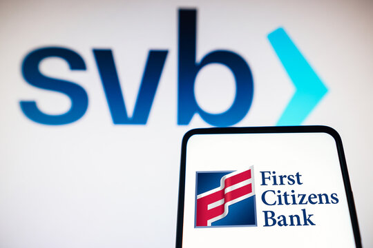 March 20, 2023, Brazil. In this photo illustration the First Citizens Bank logo seen displayed on a smartphone and Silicon Valley Bank (SVB) logo on the background.