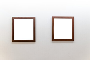 Blank wooden picture frames on concrete wall