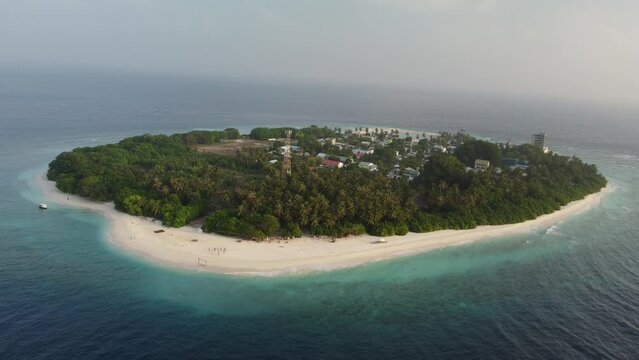 Tropical paradise with blue sea and green island in the maldives