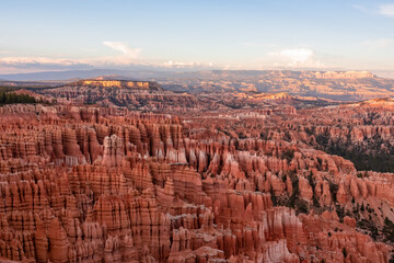 Aerial sunset view of massive hoodoo sandstone rock formation boat mesa in Bryce Canyon National Park, Utah, USA. Last sun rays touching on natural unique amphitheatre sculpted from red rock. Twilight