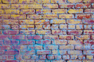 Colorful brick wall with blues yellow and reds