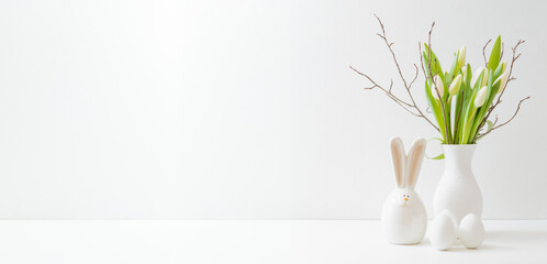 White spring tulips in a vase, easter eggs on a white table. Mock up for displaying works