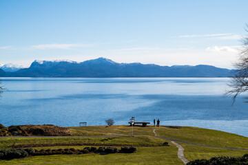 People in quiet landscape along the fjord