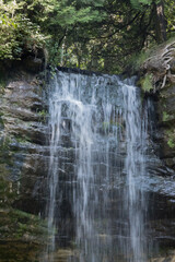 Fototapeta na wymiar Waterfall outdoors over rocks