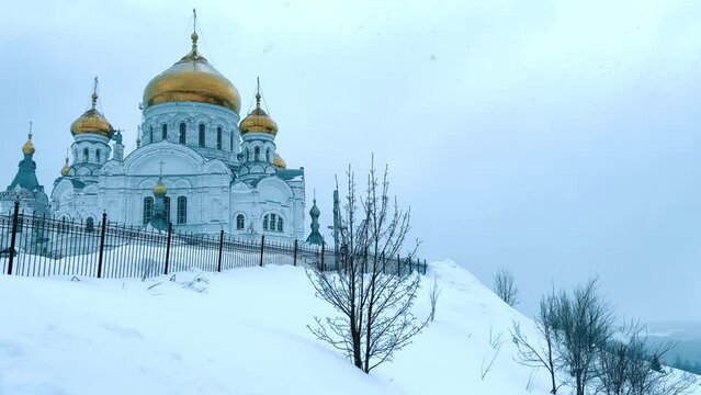 Belogorsky St. Nicholas Orthodox Missionary Monastery. Russia, Perm Krai, Belaya Gora. The temple on the hill in winter. Monastery on the background of snow. 4K