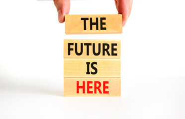 The future is here symbol. Concept words The future is here on wooden block. Beautiful white table white background. Businessman hand. Motivational business the future is here concept. Copy space.