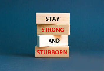 Stay strong and stubborn symbol. Concept words Stay strong and stubborn on wooden block. Beautiful grey table grey background. Motivational business stay strong and stubborn concept. Copy space.