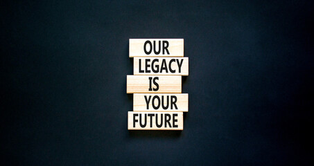 Legacy and future symbol. Concept words Our legacy is your future on wooden blocks. Beautiful black table black background. Business legacy and future concept. Copy space.