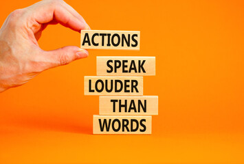 Actions speak louder words symbol. Concept words Actions speak louder than words on wooden blocks....