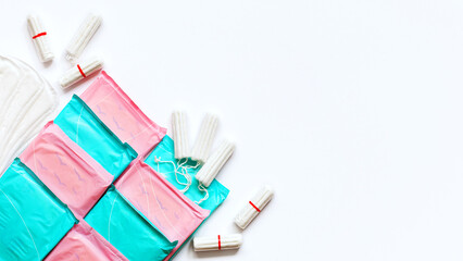 Menstruation cotton sanitary pads and tampons on white background.Soft tender protection for women critical days. Concept: feminine hygiene, gynecological menstruation cycle. Flat lay. Copy space.