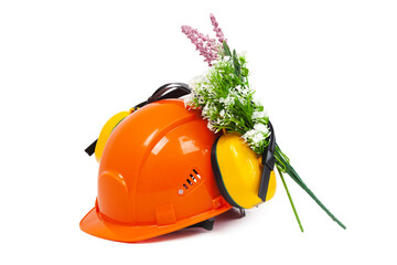 Close-up of an orange hard hat, safety, construction helmet and Noise-cancelling headphones,...