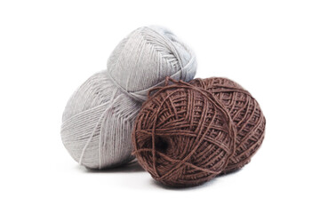 Knitting essentials. knitting or crafting concept. White and brown yarns are lying on a white isolated background. Copy space.