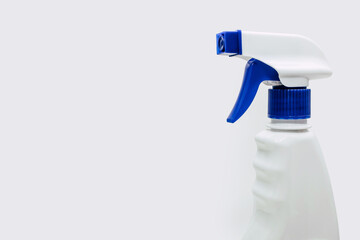 Plastic bottle with detergent on a white background with a spray bottle. Detergent for cleaning and disinfecting rooms and washing windows or dishes with a spray function. Free space for text