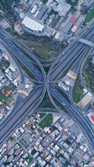 Aerial drone multilevel junction overpass highway with National toll road at rush hour with...