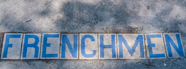 Vintage Frenchmen Street Tile Inlay on Sidewalk in New Orleans, Louisiana, USA	