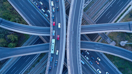 Aerial drone top down photo of modern Attiki Odos toll multilevel interchange highway with National road in Attica area at sunset, Athens, Greece