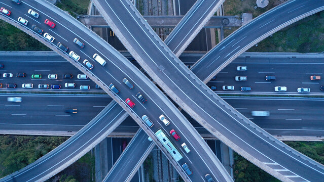 Aerial drone multilevel junction overpass highway with National toll road at rush hour with moderate traffic