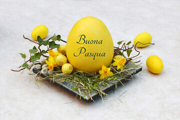 Cartolina d'auguri di buona Pasqua: nido di Pasqua con uova di Pasqua gialle e un uovo di Pasqua...