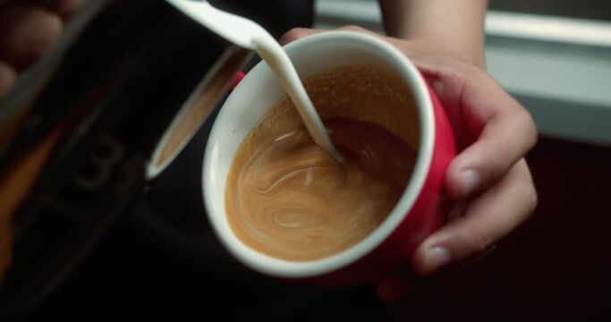 Coffee Barista slow motion Art of Coffee in red mug. Drinking roasted black coffee in the morning. 4K