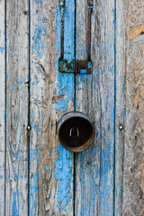 pastel wood wooden white blue with plank wall texture background giving a feeling of old and beautiful. Old blue door with a brass padlock. The padlock is rusty