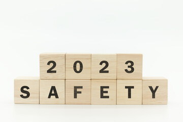 Wooden cubes 2023 and safety text on white background. Work safety in 2023. Safety first, caution...