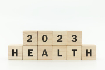 Wooden cubes 2023 with text "HEALTH" on white background and copy space. Health management and trend concept in 2023. Medical healthcare business and personal healthcare.