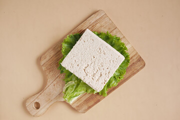 top view of slice of tofu on a chopping board on table 