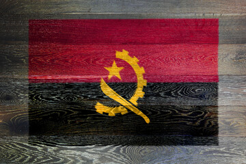 Angola flag on rustic old wood surface background