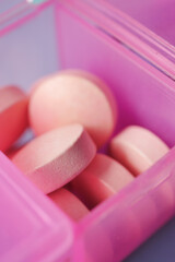 close up of medical pills in a pill box on table 