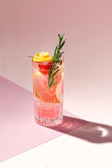 Cold alcoholic or non-alcoholic cocktail on pastel background. Hard light, deep shadow.