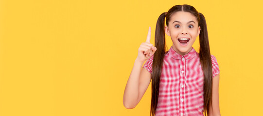 Happy girl child genius got idea pointing finger up yellow background, eureka. Child face, horizontal poster, teenager girl isolated portrait, banner with copy space.