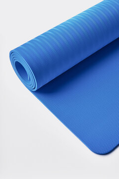 Yoga mat rolled up in roll on white background