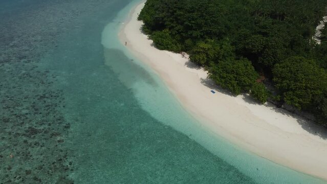 Tropical paradise with blue sea and green island in the maldives
