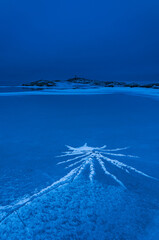 Ice patterns on frozen sea at dusk