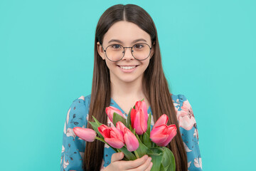 face of happy child in glasses with tulips. mothers or womens day. kid hold flowers