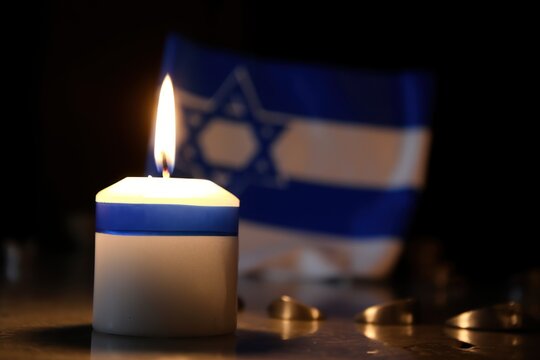 International Holocaust Remembrance Day, January 27 or Israel Memorial day.
 World War II Remembrance Day. Jewish Star of David, candle and flag of Israel.