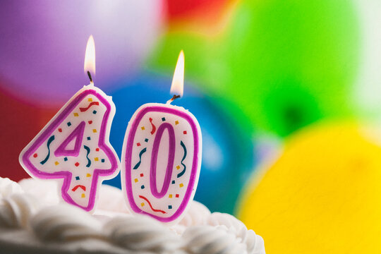 Number 40 Birthday Candles Against Colorful Balloon Background