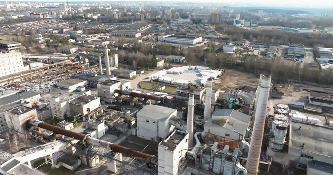 flight and aerial panoramic view of pipes as of an old abandoned factory